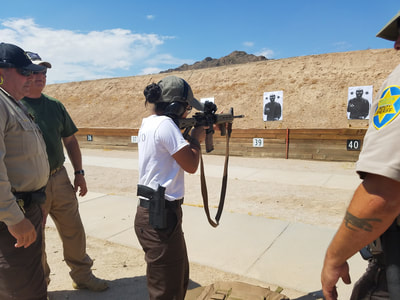 Female shooting rifle at gun range